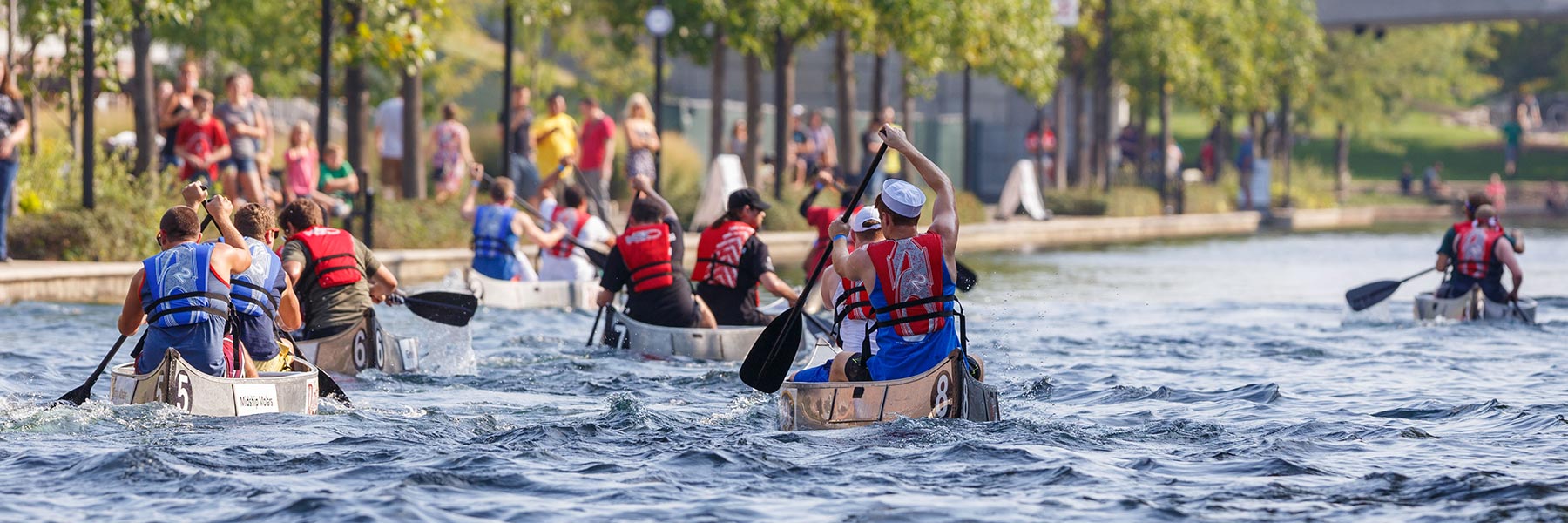 People compete in boats at the regatta.