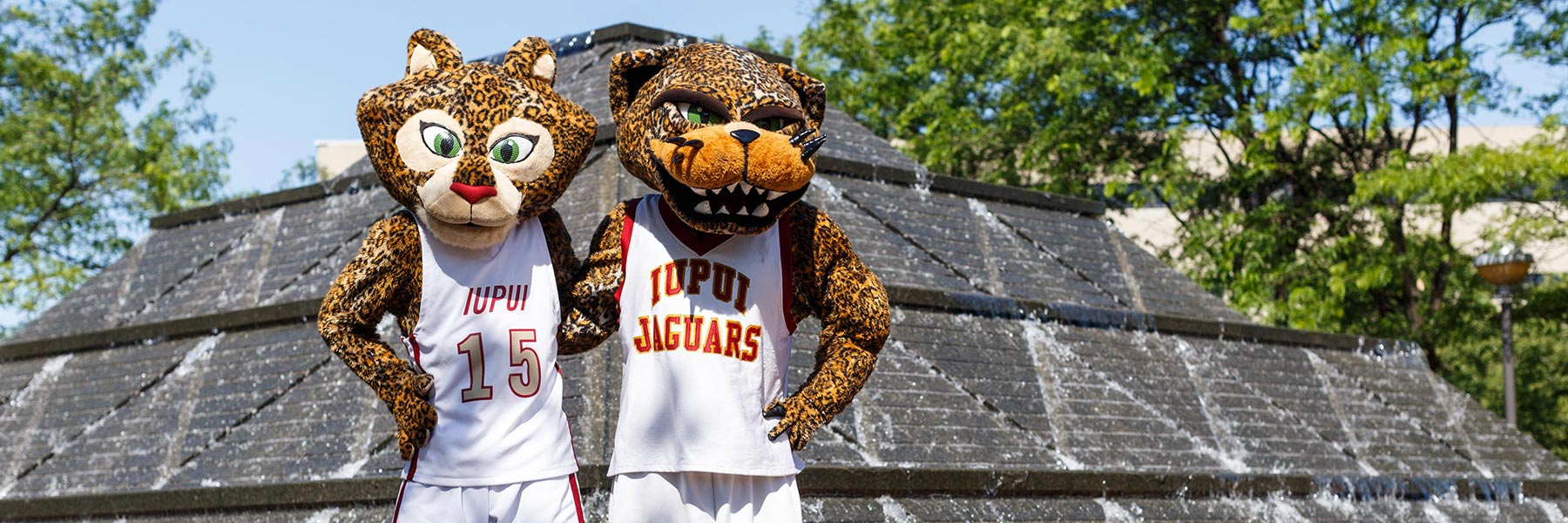 The jaguar mascots pose for a photo.