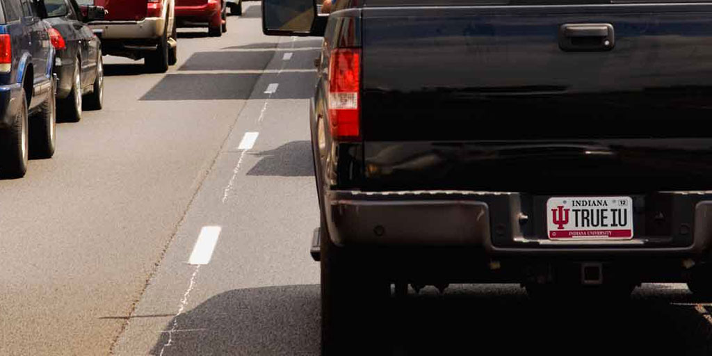 Black truck in traffic with IU Alumni license plate